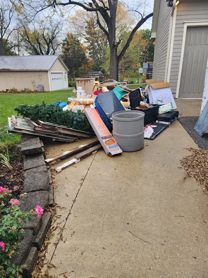 Dumpster being loaded with debris for Estate Cleanout Dumpster Rental in Coolbaugh
